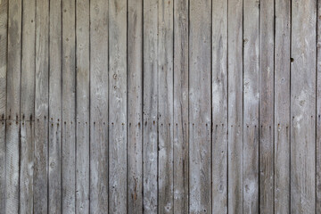 Front view of an old, weathered and aged wooden wall. Abstract full frame textured background.