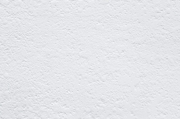 Uneven and bumpy wall painted in white, front view. High resolution full frame textured background. Copy space.