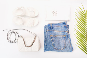 Modern female clothing, sandals and bag on white background top view.