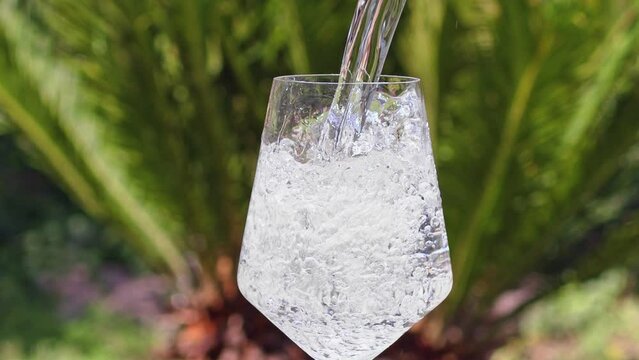 Pure Water Poured Into Glass Closeup. Slow motion. Clear fresh drinking water filling glass. Quenching thirst concept. High quality 4k footage