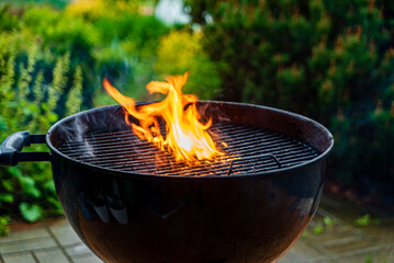 black barbecue with burning coals outside