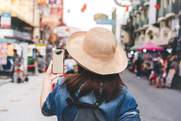 Rear view of young asian woman travel at southeast asia street market at outdoor on day