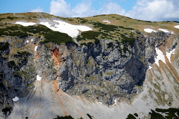 alpine landscape with red stones