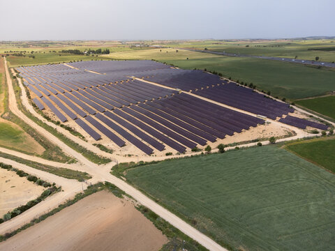 Aerial view of part of a large solar energy generation farm also called solar park, for the supply of merchant power into the electricity grid