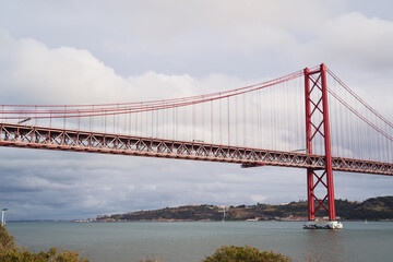 Fototapeta na wymiar Beautiful landscape with suspension 25 April bridge bridge over the Tagus river in Lisbon, Portugal.