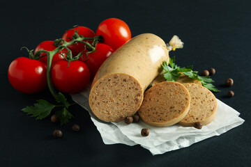 Concept of tasty food with liverwurst sausage on black background