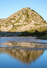 mountain with the light of dawn reflecting on a lake