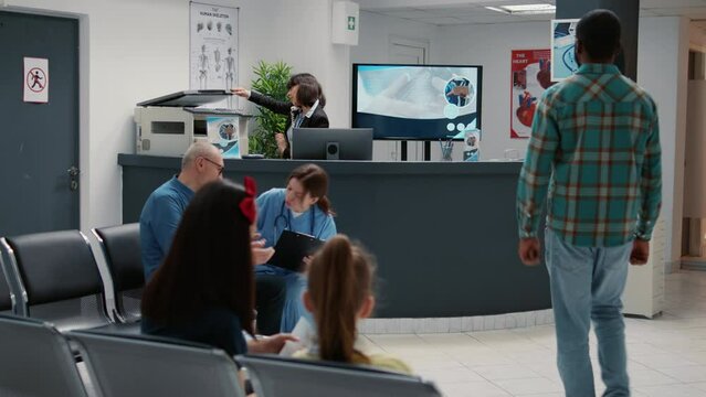 Busy hospital reception waiting area with patients in row to start medical consultation at healthcare facility. Waiting room to attend examination with doctor and checkup visit appointment.