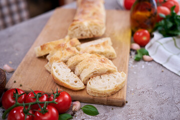 Sliced French bread baguette on wooden bread board