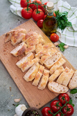 Sliced French bread baguette on wooden bread board