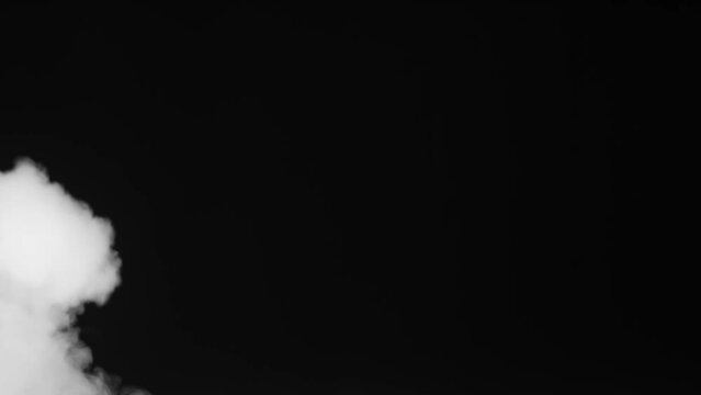 Smokejet Struggles with Airflow. A stream of white smoke fights against a headwind on a black background