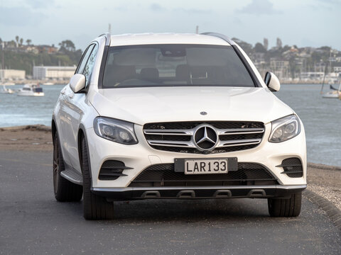 White Mercedes-Benz GLC Generation I (X253) (2015-2019). Front view. Stock photo. Auckland, New Zealand