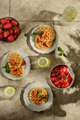 waffles with strawberries and sauce