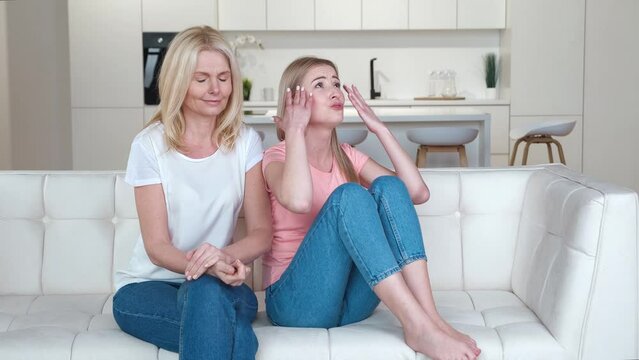 Angry adult daughter with scolding turned back not listening, outraged by disagreement with old senior mother. Two different age generation women family having fight conflict