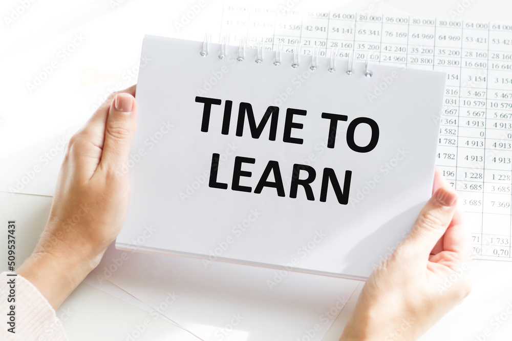 Poster businessman holds in his hands a notebook with the text: time to learn