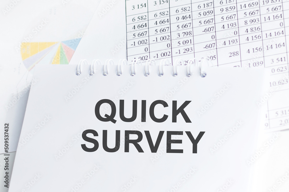 Poster quick survey inscription on a notepad on the table next to reports and charts