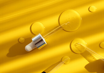 pipette drop of serum test on a yellow background sun glare	
