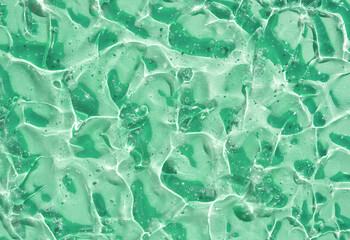 texture gel serum smear on green background	
