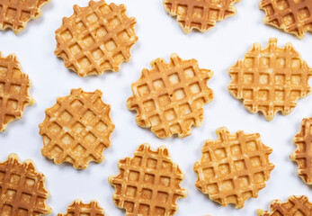 background of appetizing sweet waffles on a blue background. Summer, bright, trendy background, food design