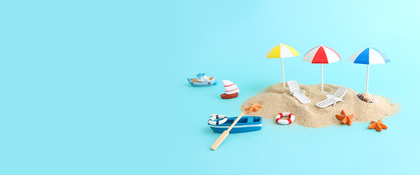 holidays image of tropical sea and beach chairs under umbrellas. Summer travel and vacation concept