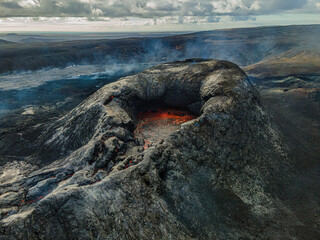 View into the crater with red lava in the mouth. Landscape in Iceland. Volcanic crater on Reykjanes...