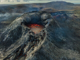 Active volcano in Iceland. View of the volcanic crater. Red lava in the mouth of the volcano on the...