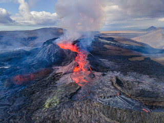 Lava flow with glowing hot magma at volcanic eruption in Iceland. View into the volcanic crater...