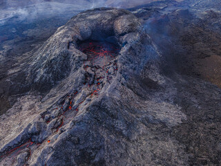 View of the volcanic crater. Structures of red lava in the crater mouth. Volcano just before...