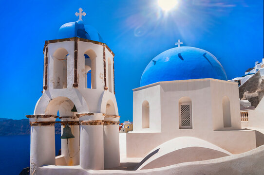 Iconic  blue domes churches  of most beautiful  romantic island  - Santorini,  Oia village, Cyclades . Greece