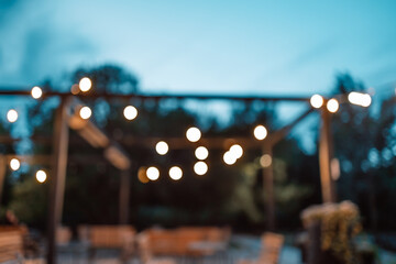 Blurred image of the terrace interior with garland lights. Abstract image. 