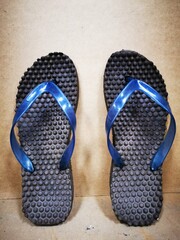 Image a pair of used rubber slipper.