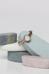 Jewelry fashion photography. Costume jewelry rings displayed on decorative oval stones, studio product shot.