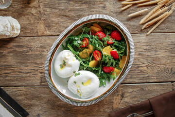 Closeup on bowl of boiled eggs with fresh healthy salad