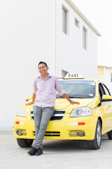 Portrait of Ecuadorian taxi driver. Yellow taxi in Ecuador. Copy space.