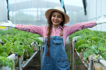 Happy woman   in greenhouse.   Woman in hydro farm .
