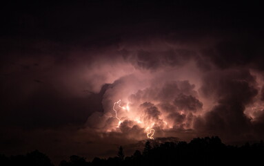 Lightning in the sky during a storm at night