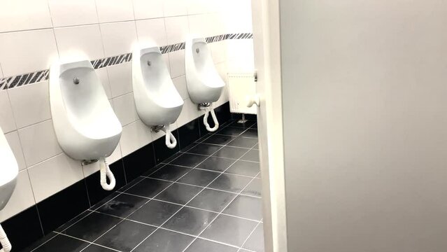 public toilet urinals. men a toilet in the office general plan indoor urinals. interior of the toilet in the mall. wall-mounted public lifestyle toilet inside view