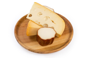 Smoked processed cheese and semi-hard cheese on wooden dish