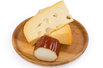 Smoked processed cheese and semi-hard cheese on wooden dish