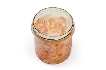 Braised pork in open small jar on a white background