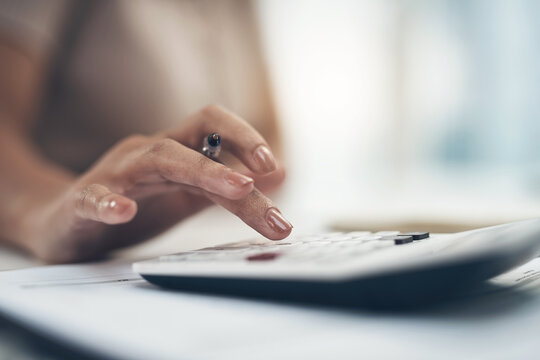 Staying Financially Savvy To Become Successful. Closeup Shot Of An Unrecognisable Businesswoman Calculating Finances In An Office.