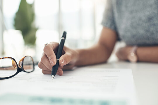 Updating Company Policies. Closeup Shot Of An Unrecognisable Businesswoman Going Through Paperwork In An Office.