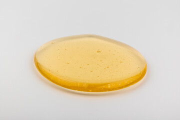 Honey flows. Drops of yellow syrup flow. Natural product and sweet drink. Isolated on white background.