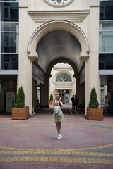 woman walking in front of building