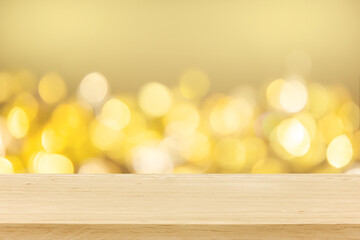 Christmas holiday golden background with empty wooden deck table over winter bokeh. Ready for...
