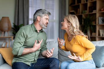 Marriage Problems. Portrait Of Middle Aged Spouses Quarreling At Home - obrazy, fototapety, plakaty