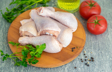Raw meat chicken drumsticks on a board. Selective focus.