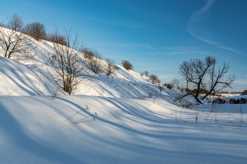 Winter nature landscape. Snowy slopes sunlight. Photo for decoration and design