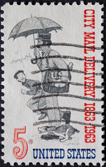 UNITED STATES - CIRCA 1963: a postage stamp from UNITED STATES , showing a postman with mail bag...