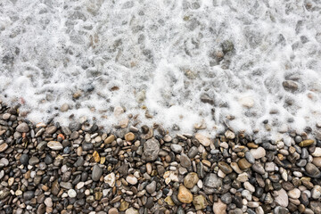 Rocky beach and pebble stones at sea
